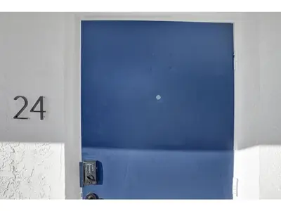 a blue door with the number on it at Rustic Retreats Beachy 1BR for 4 guests in the heart of Fort Lauderdale in Fort Lauderdale