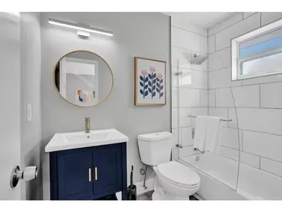 a bathroom with a toilet and a sink and a mirror at Rustic Retreats Beachy 1BR for 4 guests in the heart of Fort Lauderdale in Fort Lauderdale
