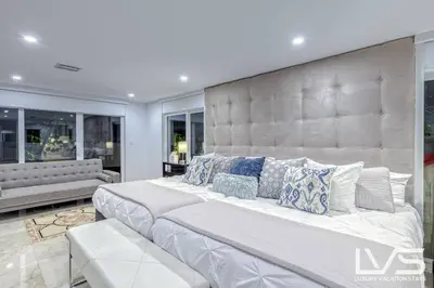 a large white bed with pillows on it in a room at Cascada-Luxe Resort Heated Pool HotTub Wlk 2 Beach in Fort Lauderdale