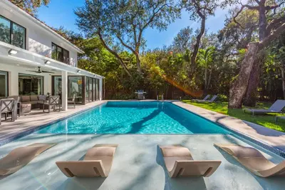 a swimming pool in the backyard of a house at Villa Arielle in Miami