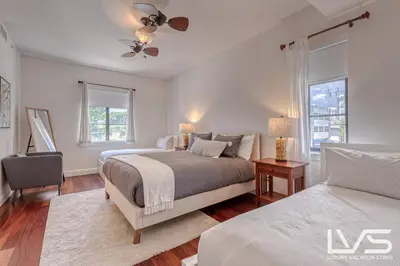 a bedroom with two beds and a ceiling fan at LVS Villa Alba- Walk2LasOlas, HeatedPool, RoofTopTerrace in Fort Lauderdale