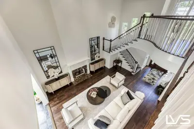 a living room with a white couch and a staircase at Poinciana-LuxeHome Wlk2Beach HeatedPool HotTub in Fort Lauderdale