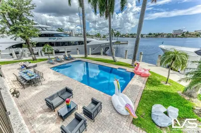 a luxury house with a swimming pool and a boat at VillaKey- LUXE Waterfront Villa 5Min to Beach in Fort Lauderdale