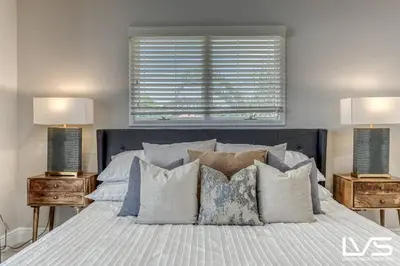 a bedroom with a bed with pillows and two lamps at VillaKey- LUXE Waterfront Villa 5Min to Beach in Fort Lauderdale
