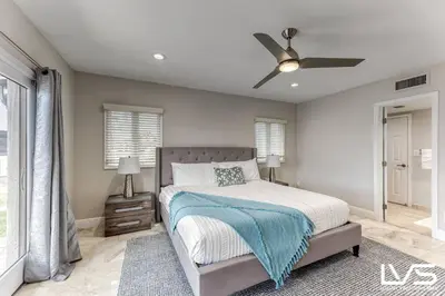 a bedroom with a bed and a ceiling fan at VillaKey- LUXE Waterfront Villa 5Min to Beach in Fort Lauderdale