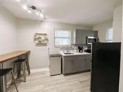 a kitchen with a refrigerator and a sink in it at Rustic Retreats Modern 1BR for 4 guests in the heart of Fort Lauderdale in Fort Lauderdale
