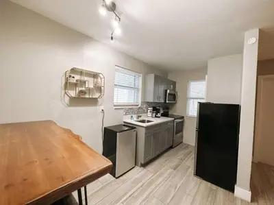 a kitchen with a sink and a table in it at Rustic Retreats Modern 1BR for 4 guests in the heart of Fort Lauderdale in Fort Lauderdale