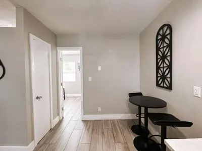 a room with a table and two stools in it at Rustic Retreats Cozy 1BR For 4 Guests Minutes From Las Olas in Fort Lauderdale