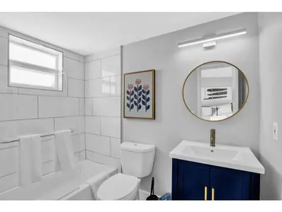a bathroom with a sink and a toilet and a mirror at Rustic Retreats Cozy 1BR For 4 Guests In The Heart Of Fort Lauderdale in Fort Lauderdale