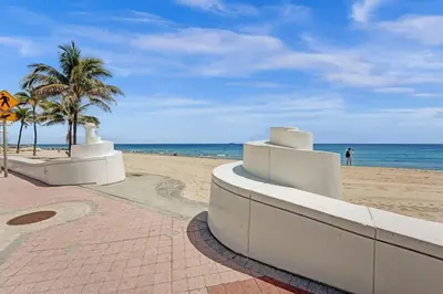 a sandy beach with palm trees and the ocean at Rustic Retreats Cozy 1BR for 4 guests minutes from Las Olas in Fort Lauderdale