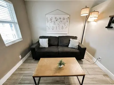 a living room with a couch and a coffee table at Rustic Retreats Beachy 1BR for 4 guests in the heart of Fort Lauderdale in Fort Lauderdale