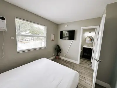 a bedroom with a white bed and a window at Rustic Retreats Beachy 1BR for 4 guests in the heart of Fort Lauderdale in Fort Lauderdale