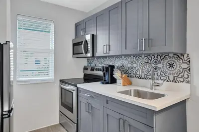 a kitchen with a sink and a stove at Rustic Retreats Cozy 1BR for 2 guests minutes from Las Olas in Fort Lauderdale