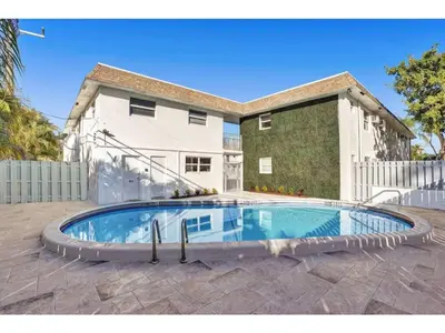 a swimming pool in front of a house at Rustic Retreats Modern 1BR for 2 guests in the heart of Fort Lauderdale in Fort Lauderdale
