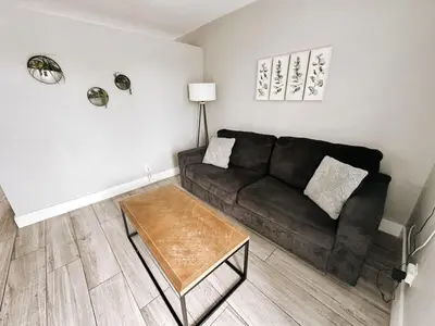 a living room with a black couch and a coffee table at Rustic Retreats Modern 1BR for 4 guests in the heart of Fort Lauderdale in Fort Lauderdale