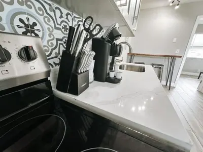 a kitchen with a counter with utensils on it at Rustic Retreats Modern 1BR for 4 guests in the heart of Fort Lauderdale in Fort Lauderdale