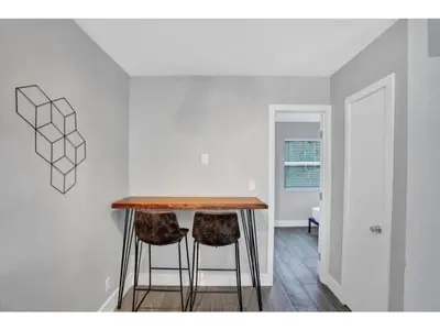 a dining room with a table and two stools at Rustic Retreats Beachy 1BR for 4 guests in the heart of Fort Lauderdale in Fort Lauderdale