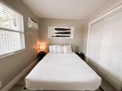 a large white bed in a room with a window at Rustic Retreats Cozy 1BR For 4 Guests Minutes From Las Olas in Fort Lauderdale