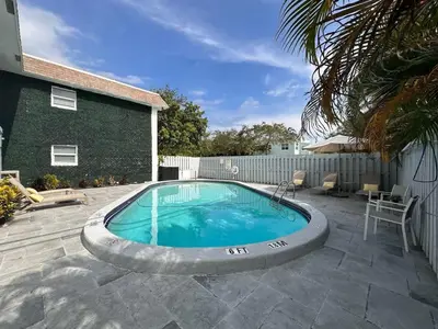 a swimming pool in the middle of a yard at Rustic Retreats Cozy 1BR For 4 Guests Minutes From Las Olas in Fort Lauderdale