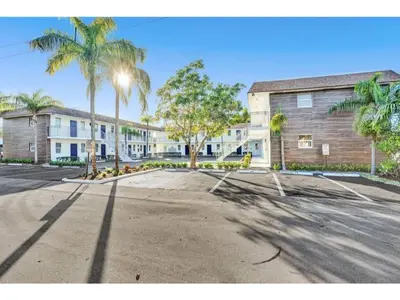 an empty parking lot in front of a building at Rustic Retreats Beachy 1BR for 4 guests in the heart of Fort Lauderdale in Fort Lauderdale