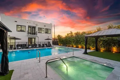 a swimming pool in the backyard of a house at Lux Retreat By Renzzi in Miami