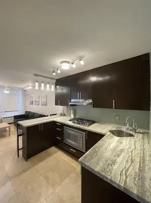 a kitchen with a sink and a stove top oven at South Beach Escape in Miami Beach