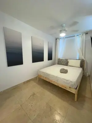 a bedroom with a bed and two pictures on the wall at South Beach Escape in Miami Beach
