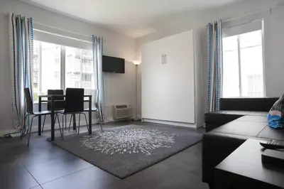 a living room with a table and chairs and a couch at Miami Beach Getaway 100 yards from Beach in Miami Beach