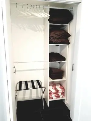 a walk in closet with white walls and shelves at Miami Beach Getaway 100 yards from Beach in Miami Beach
