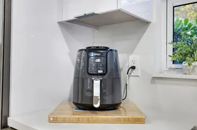 a black coffee maker on a counter in a kitchen at Modern villa in Design District ! in Miami
