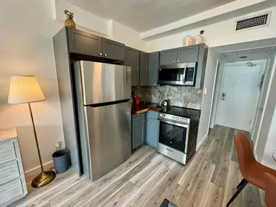 a kitchen with a stainless steel refrigerator at Directly on the Beach with Pool & Parking in Miami Beach