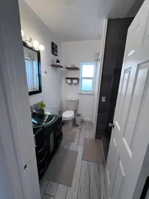 a bathroom with a sink and a toilet at Cozy room in a quiet home in Miami