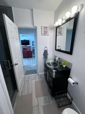 a bathroom with a sink and a mirror at Cozy room in a quiet home in Miami