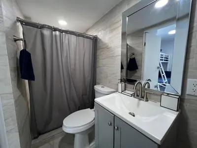 a bathroom with a toilet and a sink and a shower at Charming two bedroom apartment. in Miami