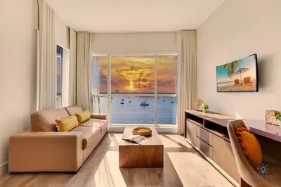 a living room with a couch and a large window at Costa Hollywood Beach in Hollywood