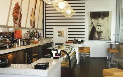 a restaurant with a bar with a picture on the wall at Riu Plaza Miami Beach in Miami Beach