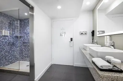 a bathroom with two sinks and a shower at Riu Plaza Miami Beach in Miami Beach