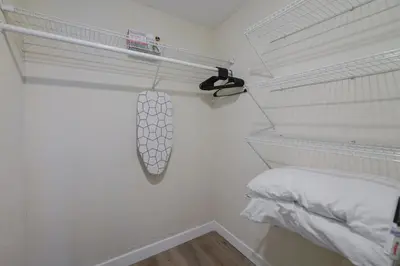 a white room with a bed and a whiteolin at Prime Location Apt on Calle Ocho in Little Havana in Miami