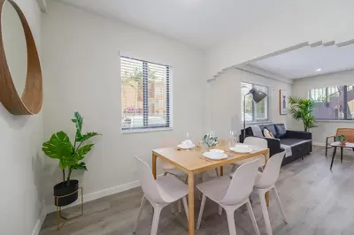 a dining room and living room with a table and chairs at Prime Location Apt on Calle Ocho in Little Havana in Miami