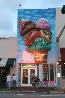 a sign on the side of a building with people standing outside at Prime Location Apt on Calle Ocho in Little Havana in Miami