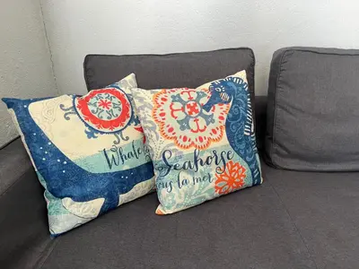a couch with two pillows sitting on it at Ocean Dream by the Beach in Miami Beach