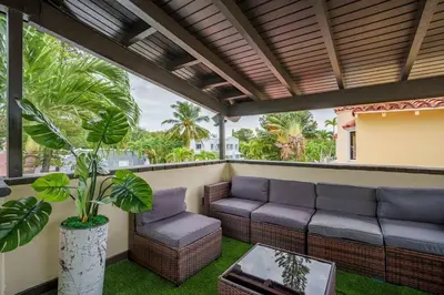 a patio with a couch and chairs and a table at New! Miami & Calle Ocho Simpson's Funhouse! in Miami
