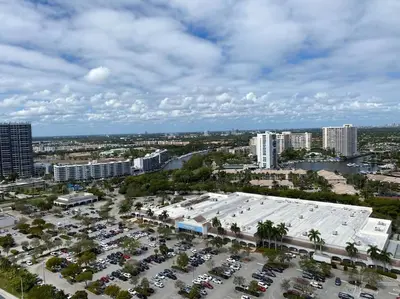 an aerial view of a parking lot in a city at Breathtaking Views from 1BR Miami Beach Getaway in Hallandale Beach