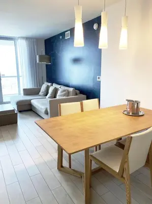 a living room with a table and a couch at Breathtaking Views from 1BR Miami Beach Getaway in Hallandale Beach