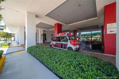 a van parked inside of a building next to a building at Cozy Beach Apartment with Full Kitchen & Ocean Views in Hallandale Beach