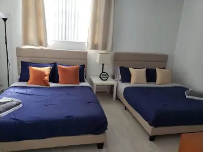 two beds in a room with blue and orange pillows at Apartment on the beach Tides Hollywood Beach 5th floor U in Hollywood