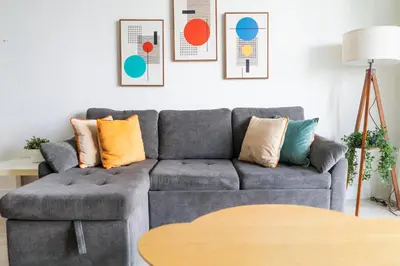 a living room with a gray couch with colorful pillows at Apartment on the beach Tides Hollywood Beach 5th floor U in Hollywood