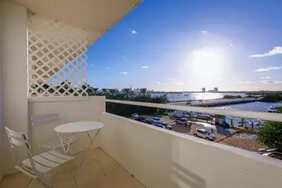 a balcony with a table and a view of a harbor at La Marinita - Marina Views Pool Parking Location in Miami Beach