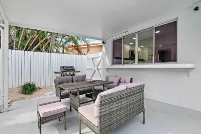 a patio with a table and chairs and a fence at Casa Azul 4Bed 2Bath Home with Heated Pool & Spa 1304 in Hollywood