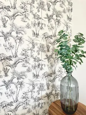 a vase sitting on a table with a plant in it at Zen Vibe on the Beach /700 SqFt in Miami Beach